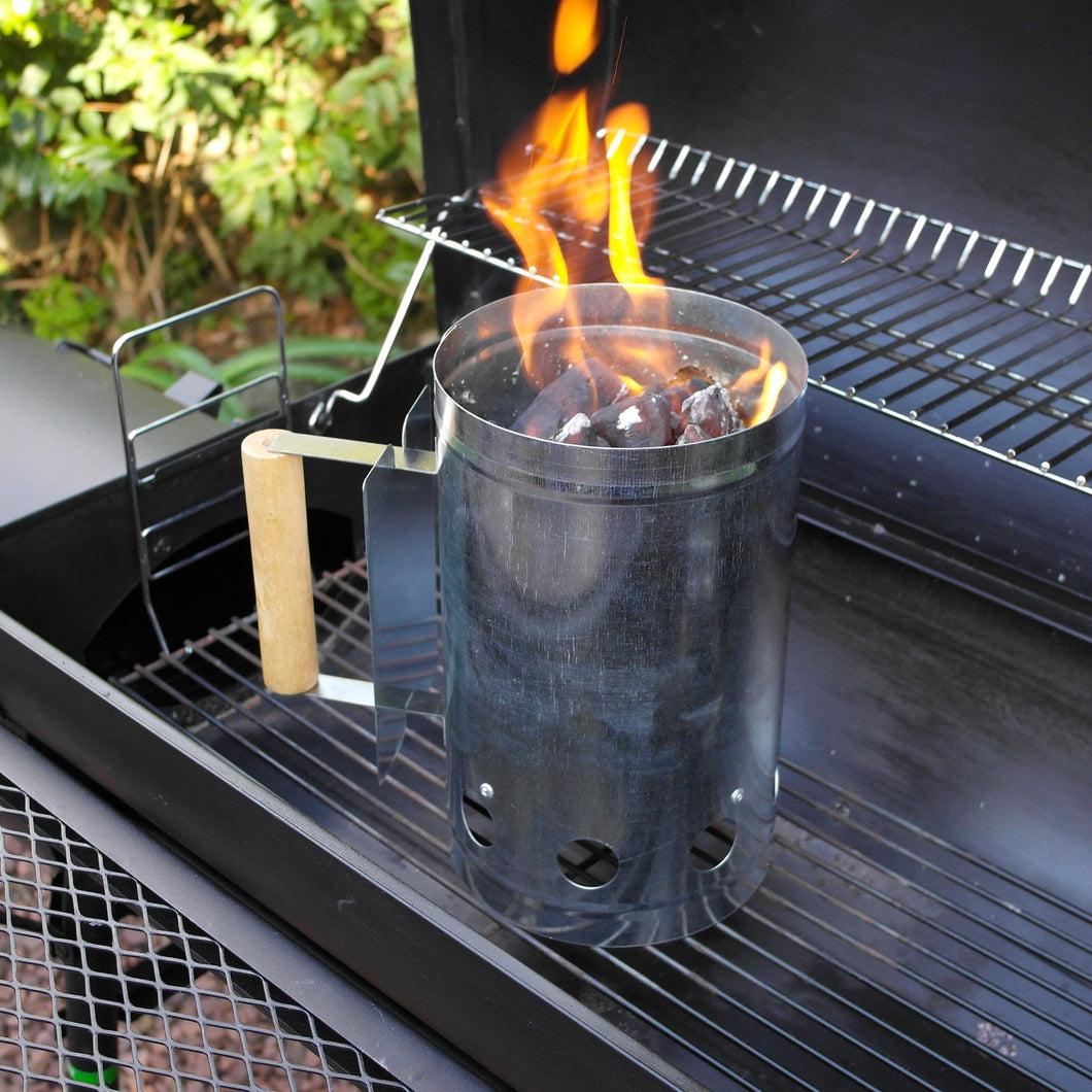 Azuma bbq charcoal chimney starter with flames.