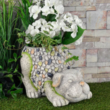 Load image into Gallery viewer, crouching dog garden planter in grey and brown mosaic pebble design filled with white flowers and ivy in a garden
