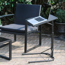 Load image into Gallery viewer, laptop stand with macbook on top beside black rattan garden chair on patio space
