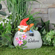 Load image into Gallery viewer, Garden gnome ornament with grey stone pebble, Welcome text, pink flowers, figure with red hat and bluebird on his boot
