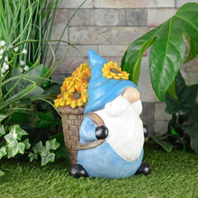 Load image into Gallery viewer, Novelty garden gnome ornament with basket of sunflowers and blue hat, standing on the grass in a garden with ivy, plants and a stone wall
