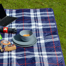 Load image into Gallery viewer, blue and red tartan picnic blanket on grass with picnic essentials laid out on top
