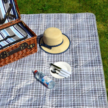 Load image into Gallery viewer, picnic blanket laid out on grass with picnic basket, hat, water bottle and small plate on top
