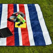 Load image into Gallery viewer, Navy blue, red an dwhite striped picnic blanket on grass with a laptop, sunglasses, book and snacks
